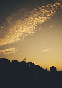 silhouette photo of buildings during sunset thumbnail