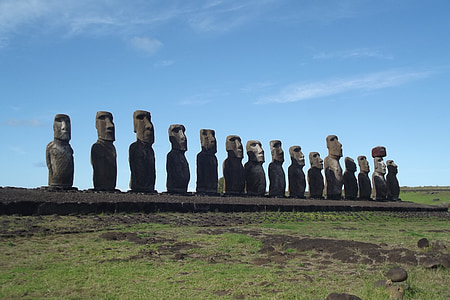 rock formation on green field under blue and white sky thumbnail