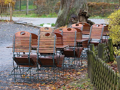 brown wooden and black metal chairs near gate thumbnail