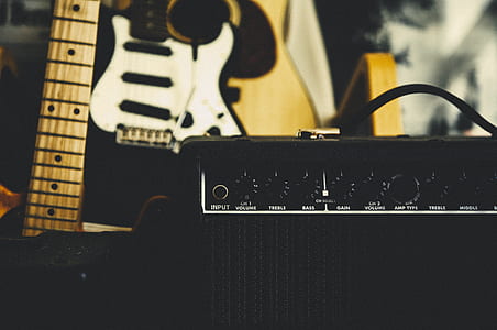 black electric guitar with amplifier thumbnail