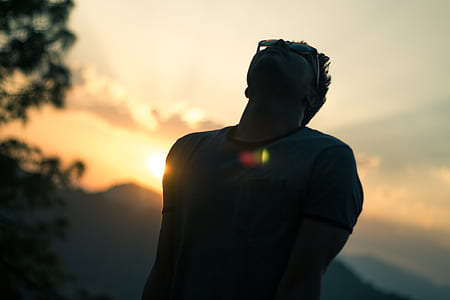 silhouette of man wearing sunglasses at sunset thumbnail