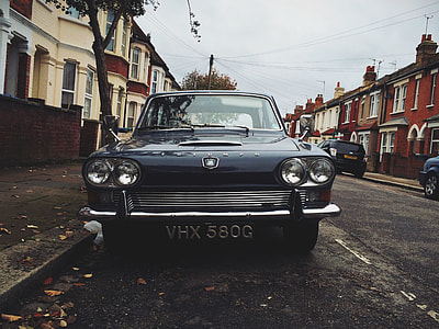 black car on street between buildings thumbnail