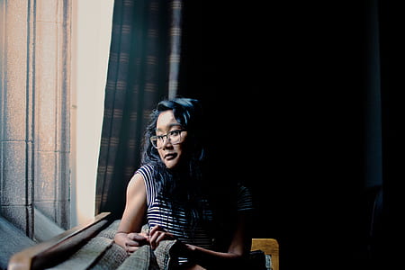 woman leaning near window thumbnail