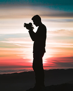 silhouette of a man holding a camera thumbnail