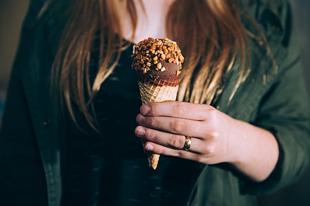 woman holding chocolate ice cream cone thumbnail