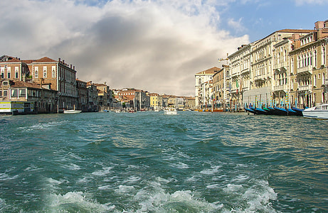 white and brown buildings near blue body of water thumbnail