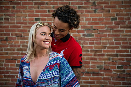 Photography of Woman in Front of Man in Red Polo Shirt thumbnail