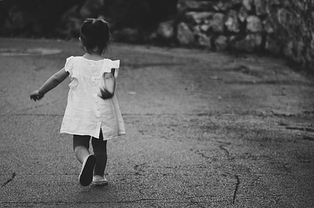 girl walking along concrete road thumbnail