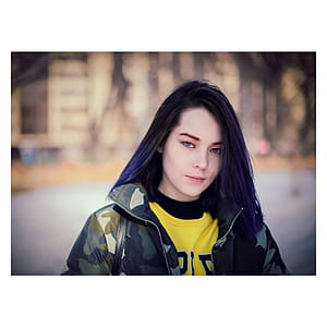 Black Haired Woman in Multicolor Camouflage Jacket thumbnail