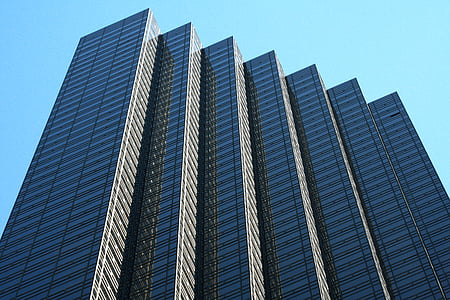 low angle photo of gray concrete buildings during daytime thumbnail