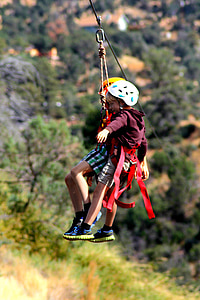 two children slide in zip line during daytime thumbnail