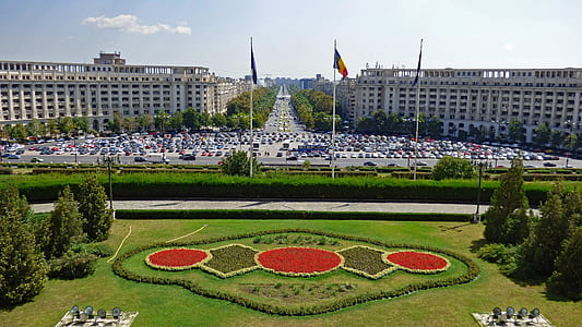aerial photography of concrete building with three flags thumbnail