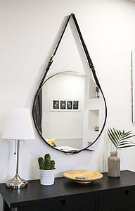 round clear glass with belt hanging on wall thumbnail