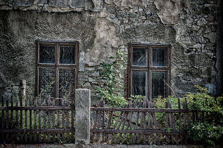 photographed of gray concrete house with brown wooden broken fences thumbnail
