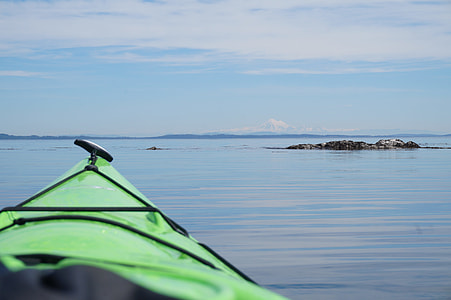 green kayak boat on body of water during daytime thumbnail