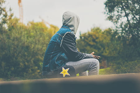 person sitting near bushes thumbnail