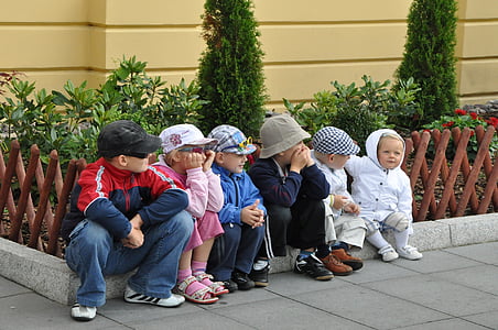 group of children sitting on floor at during time thumbnail