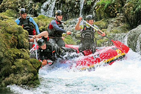 group of men rowing inflatable raft thumbnail