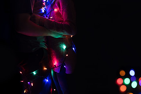 couple with assorted-color string light in bokeh photography thumbnail