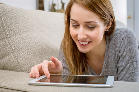 person in gray shirt infront of white tablet thumbnail