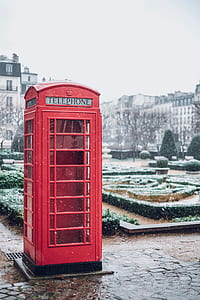 telephone booth near garden and house thumbnail