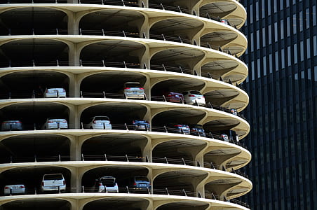 vehicles on building's parking area near other building thumbnail