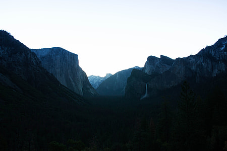silhouette photography of mountain under white sky thumbnail