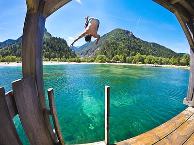 man flip diving on body of water thumbnail