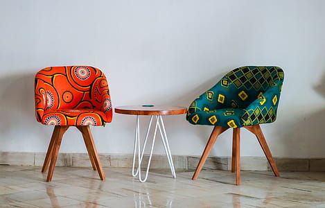 Two Assorted-color Padded Chairs Near Side Table thumbnail