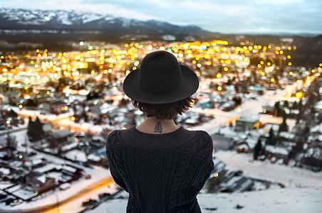 woman overlook high rise buildings during daytime thumbnail