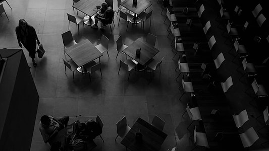 grayscale photo of people sitting on chairs thumbnail
