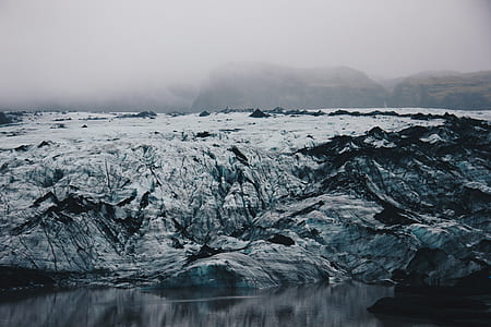 snow covered mountain near body of water thumbnail