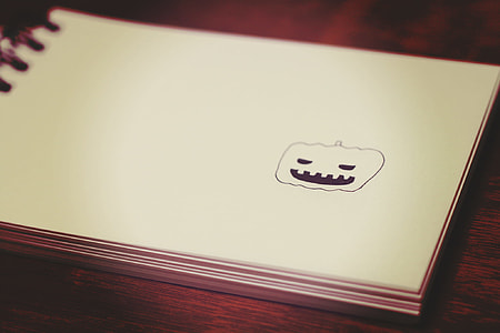 white spring notebook on brown wooden surface thumbnail