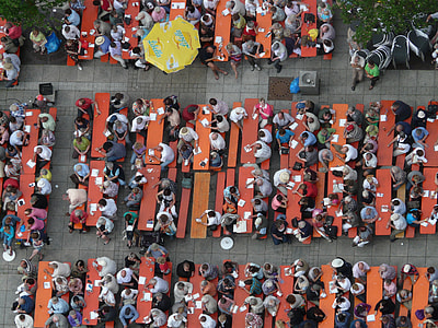aerial photography of group of people eating on bench thumbnail