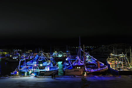 PORT DE GRAVE, NEWFOUNDLAND AND LABRADOR, CANADA - DECEMBER 22, 2017. Fishing vessels at night celebrating the Christmas season with lights, taken on December 22, 2017 in Port De Grave. thumbnail