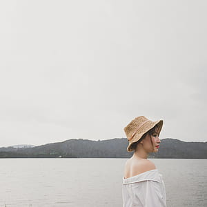 woman wearing brown hat and off-shoulder top during daytime thumbnail