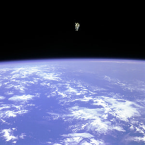 an astronaut floating outside the core of the Earth thumbnail