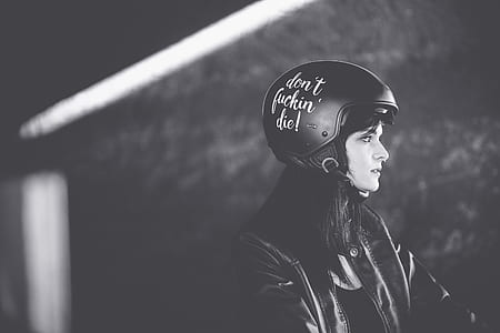 grayscaled photo of woman in black helmet thumbnail