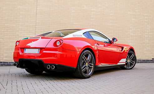 red and white Ferrari California near concrete wall thumbnail