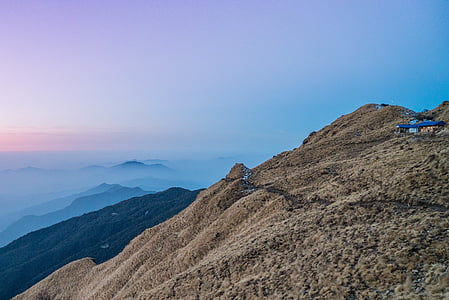 brown mountain under blue sky during daytime thumbnail