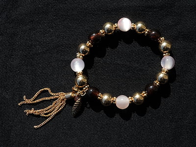 beaded brown and white bracelet on black surface thumbnail