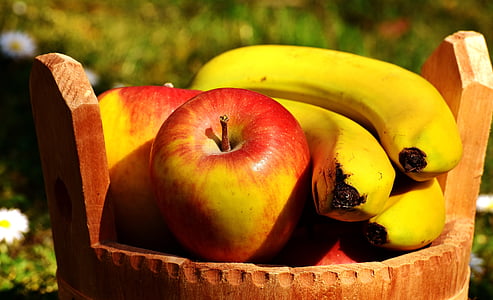 shallow focus photography of red apple and yellow banana on brown wooden basket thumbnail