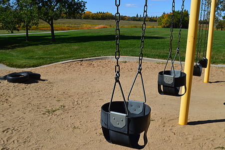 empty swing in park at daytime thumbnail