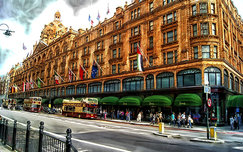 group of people walking beside building and road during daytime thumbnail
