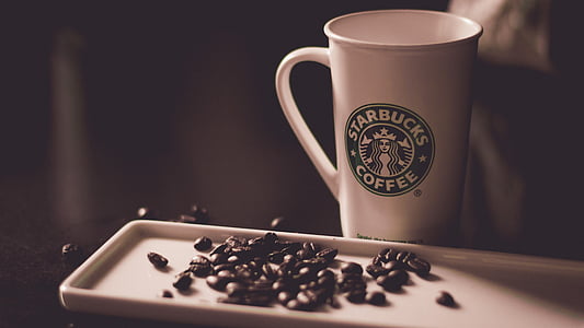 Starbucks Coffee mug beside tray with coffee bean thumbnail