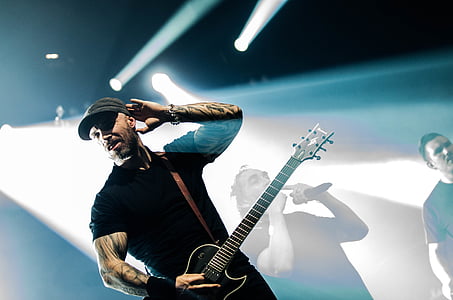 man playing guitar under track lights thumbnail