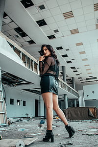 woman standing in ruined building thumbnail