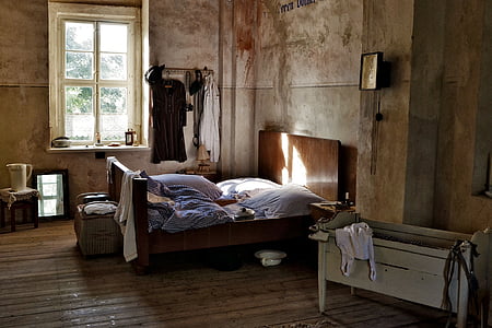 brown wooden bed in front of crib thumbnail