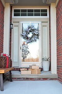 Four Brown Gift Boxes Near a Glass Paneled Door With Wreath thumbnail