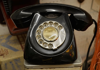 black rotary phone in gray metal surface thumbnail